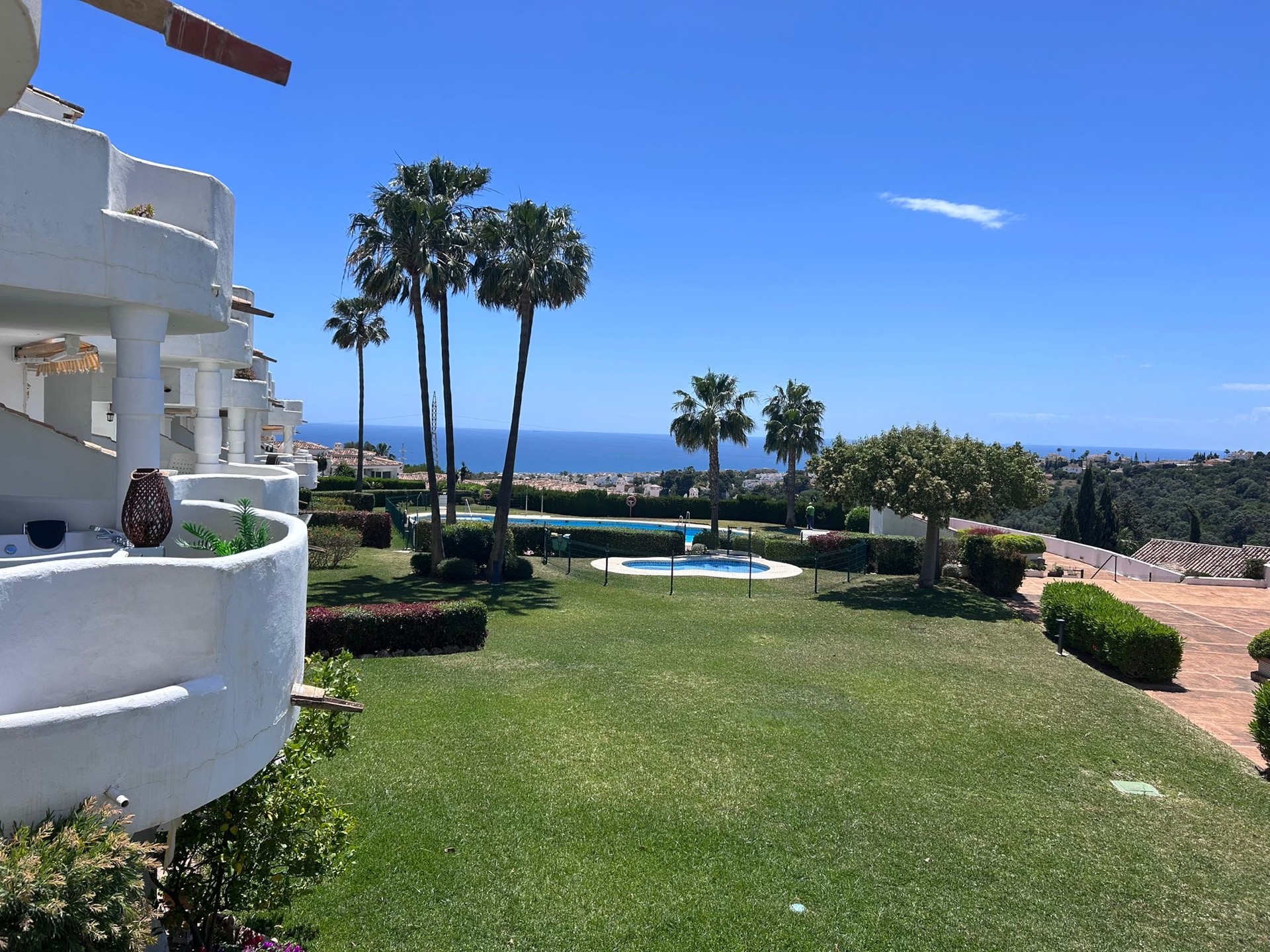 Four communal pools and palm trees with Mediterranean sea view at La Casa Neil, Calahonda