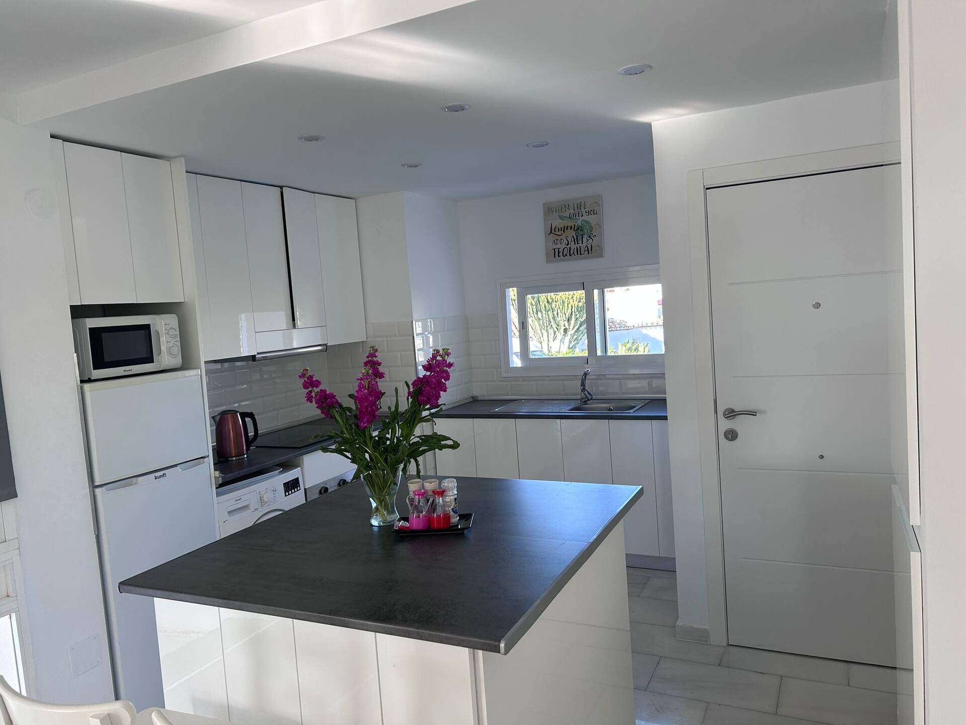 Kitchen with marble floors and full appliances at La Casa Neil, Calahonda